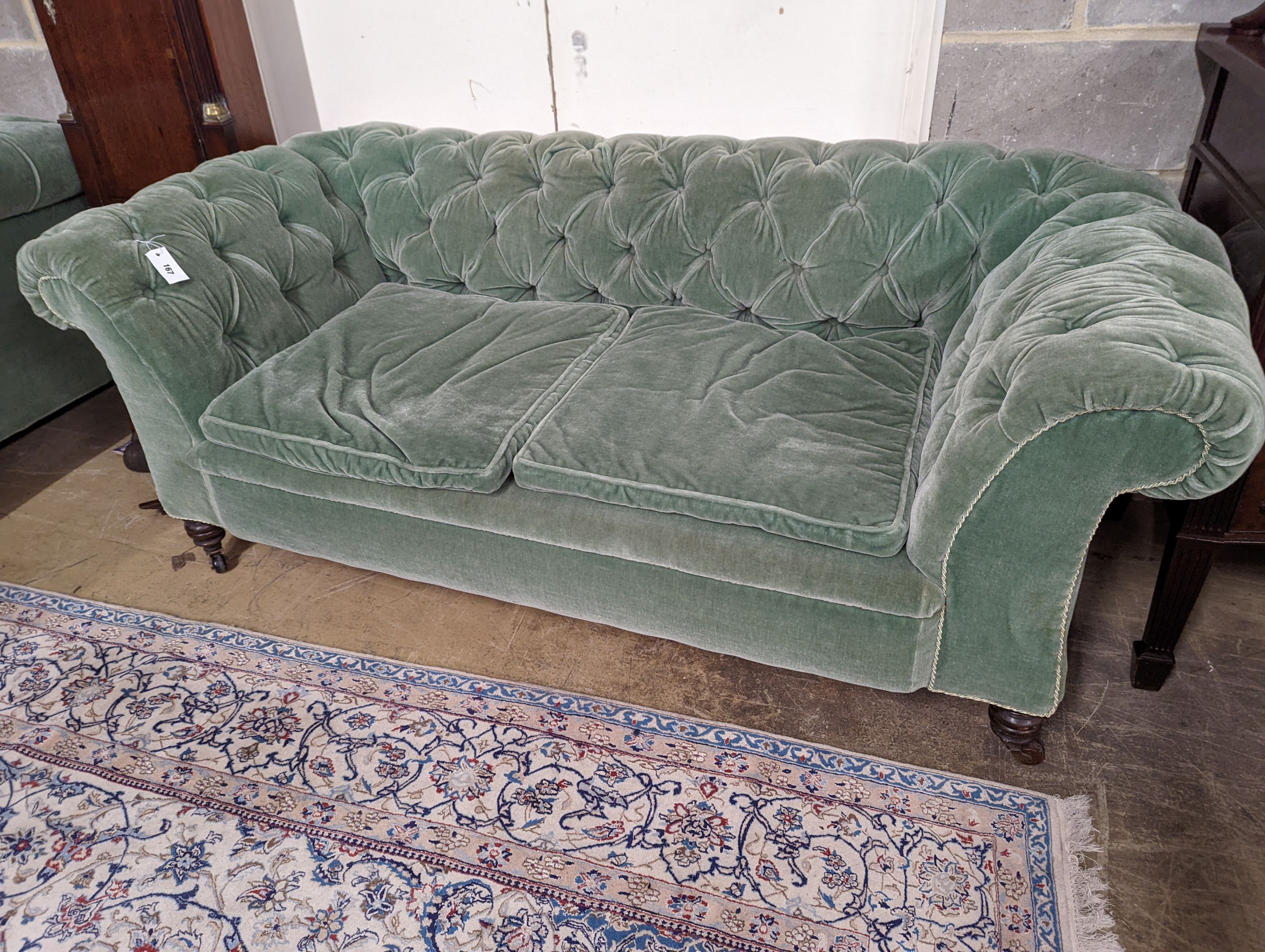 A late Victorian double drop arm Chesterfield settee upholstered in green fabric, length 186cm, depth 84cm, height 70cm